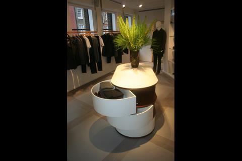 Mid-shop curved white tables that pivot to open and a statement-piece bench catch the eye